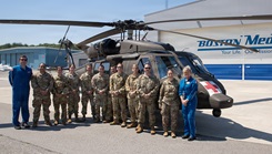 Soldiers from Det 1, Charlie Company, 3rd Battalion, 126th Aviation Regiment, General Support Aviation Battalion, leadership from 3-126th GSAB and 151st Regional Support Group pose for a photo in front of a BlackHawk with instructors from Boston MedFlight 