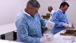 U.S. Air Force Tech. Sgt. Ryan Cannon, Air Force Health Study noncommissioned officer in charge, and Adam Irvin, quality assurance director, from the 711th Human Performance Wing prepare Air Force Health Study biospecimens for storage in freezers