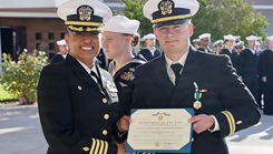 Capt. Janiese Cleckley (left), commanding officer of Navy Medicine Readiness and Training Command Twentynine Palms, presents a Navy and Marine Corps Commendation Medal to Lt. Andrew Crane during a command award ceremony