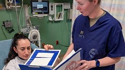 U.S. Air Force Capt. Ariel Miller, post-anesthesia care unit nurse manager, stages a patient interaction with an Airman in the PACU