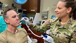1st Lt. Crystal Absher, an emergency room nurse at Bayne-Jones Army Community Hospital, checks Sgt. 1st Class Chip Allen’s temperature