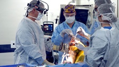 Pictured left, Cmdr. Brian Barlow, orthopedic surgeon assigned to Navy Medicine and Training Command Rota, performs a computer-assisted knee replacement procedure with his surgical team