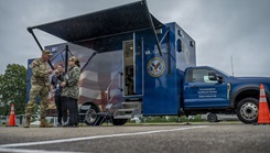  A Soldier assigned to the Connecticut National Guard's 1st Battalion, 102nd Infantry Regiment talks with a member of the Connecticut Department of Veterans Affairs Mobile Medical Team