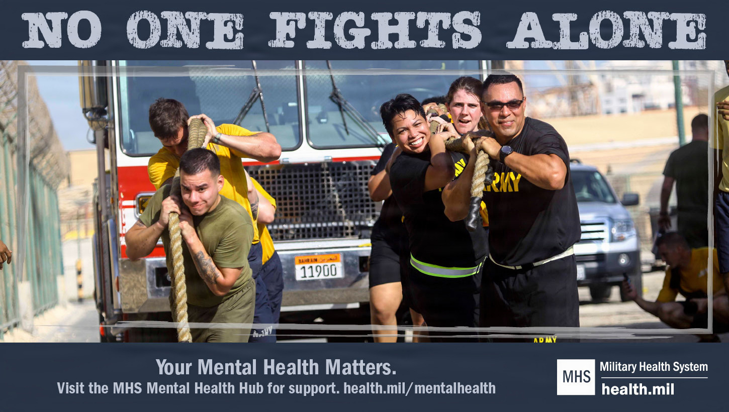 Image of A graphic of military personnel pulling a truck, with the phrase 'No one fights alone'.