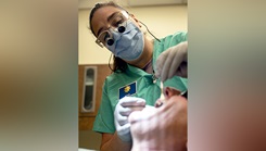 U.S. Air Force Maj. Alyssa Mann, 92nd Operational Medical Readiness Squadron dental flight commander, performs work on a patient