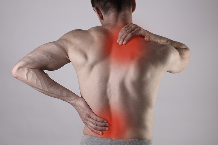 Image of Man holding his back. Click to open a larger version of the image.