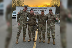 Capt. James Terrell and Capt. Seung Choi of the U.S. Army Medical Research Institute of Chemical Defense, second and third from left, catch their breath with colleagues from the USAMRICD cadre after completing the 12-mile ruck march portion of the Expert Medical Field Badge competition