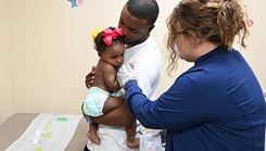 Klarissa Parsons, registered nurse, CRDAMC pediatrics, administers the MMR (measles, mumps, and rubella) vaccine to Autumn Campbell, daughter of Spc. Tyrece Campbell