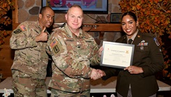 U.S. Army Spc. Fernanda Suarez (right), American Red Cross Dental Assistant training program student, receives a certificate of completion from Col. Ralf Beilhardt, the commander of the Dental Health Activity