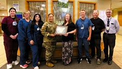 Col. Sheyla Baez Ramirez, commander of U.S. Army Garrison-Fort McCoy, presents a special certificate of appreciation July 2, 2026, to staff members of the Mayo Clinic facility