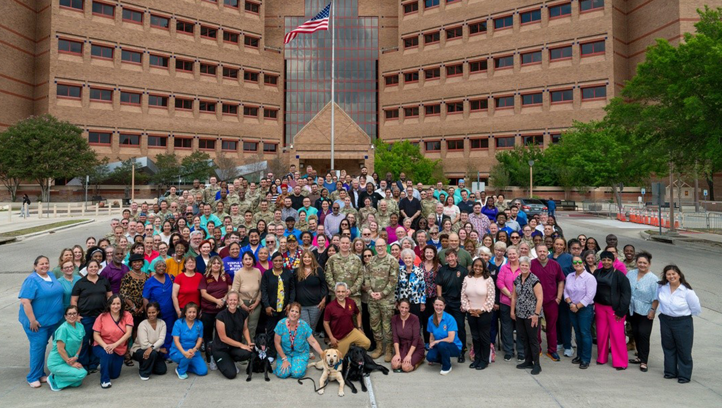 Staff members from Brooke Army Medical Center gather for a group photo 