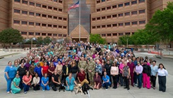 Staff members from Brooke Army Medical Center gather for a group photo 
