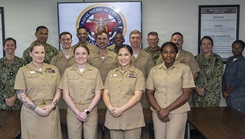 Navy officers assigned to Expeditionary Medical Facility Kilo pose with command leadership and Nursing Residency Program staff after the Training-to-Practice Nurse Residency Program graduation