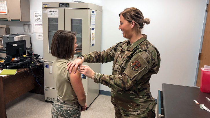 U.S. Air Force Kathryn Klein, right, an aerospace medical service specialist with 182nd Medical Group, Illinois Air National Guard, administers an influenza vaccination during drill weekend at the 182nd Airlift Wing in Peoria, Ill., Dec. 8, 2019. According to the Centers for Disease Control and Prevention, the flu is a contagious respiratory illness caused by influenza viruses, and the best prevention is getting a flu vaccine each year. (U.S. Air National Guard photo by Senior Airman Paul R. Helmig II)