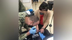 U.S. Naval Research Laboratory (NRL) Research Biologist Sophie Colston, Ph.D. and Lt. Cmdr. Chaselynn Watters of the Biological Defense Research Directorate (BDRD) Mobile laboratory team operate the sequencer during a training event 