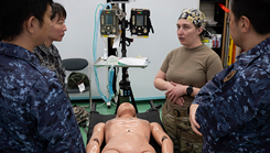 U.S. Air Force Maj. Heather Barber, 374th Surgical Operations Squadron medical director of surgical services, explains the role of the Ground Surgical Team to Japan Self-Defense Force medical personnel