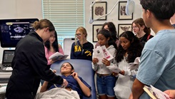 Hospital Corpsman 3rd Class Lillian Pfeiffer demonstrates ultrasound technology to students from W.T. Sampson Elementary and High School during a field trip