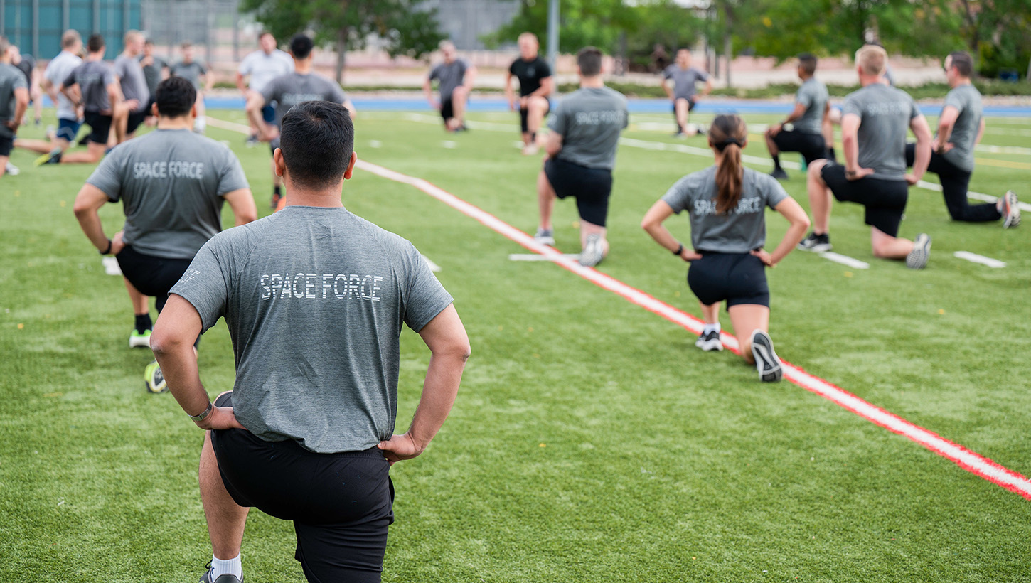 Guardians stretch before beginning the Delta 12 Summer Fitness Challenge Physical Training Field Day 
