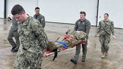 8Personnel from Helicopter Maritime Strike Squadron (HSM) 50 stationed at Naval Station (NS) Mayport practice loading patients for rapid transport while Lt. j.g. Brooke Boord of Expeditionary Medical Facility-Mike observed and instructed with other staff from Navy Medicine Readiness and Training Command (NMRTC) Jacksonville.