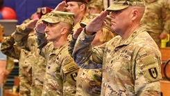Lt. Col. Andrey V. Tsepelev, left, and Lt. Col. Steven P. Delgado render honors during the national anthem