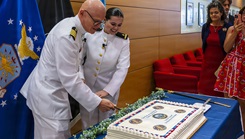 From left to right, U.S. Navy Capt. Lonnie S. Hosea, Bureau of Medicine and Surgery senior health policy advisor, and his daughter, Ensign Jenna Hosea Baker, a nurse assigned to Walter Reed National Military Medical Center, cut his retirement cake