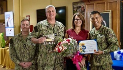 Naval Medical Readiness and Training Command (NMRTC) Rota Ombudsman, Ms. Lisa Eckard (right) was presented with a token of gratitude for her dedicated service, in honor of Ombudsman Appreciation Month