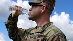 Staff Sgt. Shaun Martin, a combat medic assigned to Blanchfield’s LaPointe Army Medical Home on Fort Campbell, drinks from a 16 ounce bottle of water to maintain his hydration for optimal performance
