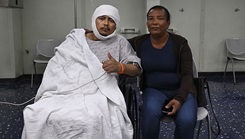 Jesus Medina smiles for a photo with his mother after a surgery aboard the Mercy-class hospital ship USNS Comfort during Continuing Promise 2025