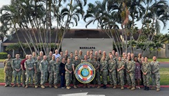 Military personnel posing with the Fleet Health Services seal