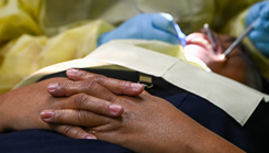 U.S. Air Force Reserve Maj. Andrew Hutchison, 419th Medical Squadron officer-in-charge of the Nevis dental team, performs a filling repair