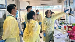 Lao collaborators learning laboratory techniques