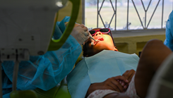 A U.S. Air Force Reserve dentist extracts a pediatric patient’s tooth at Cheddi Jagan Dental School