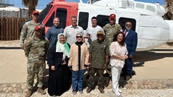 Representatives from the Multinational Force and Observers and U.S. Naval Medical Research Unit (NAMRU) EURAFCENT pose for a group photo during a visit to South Camp.