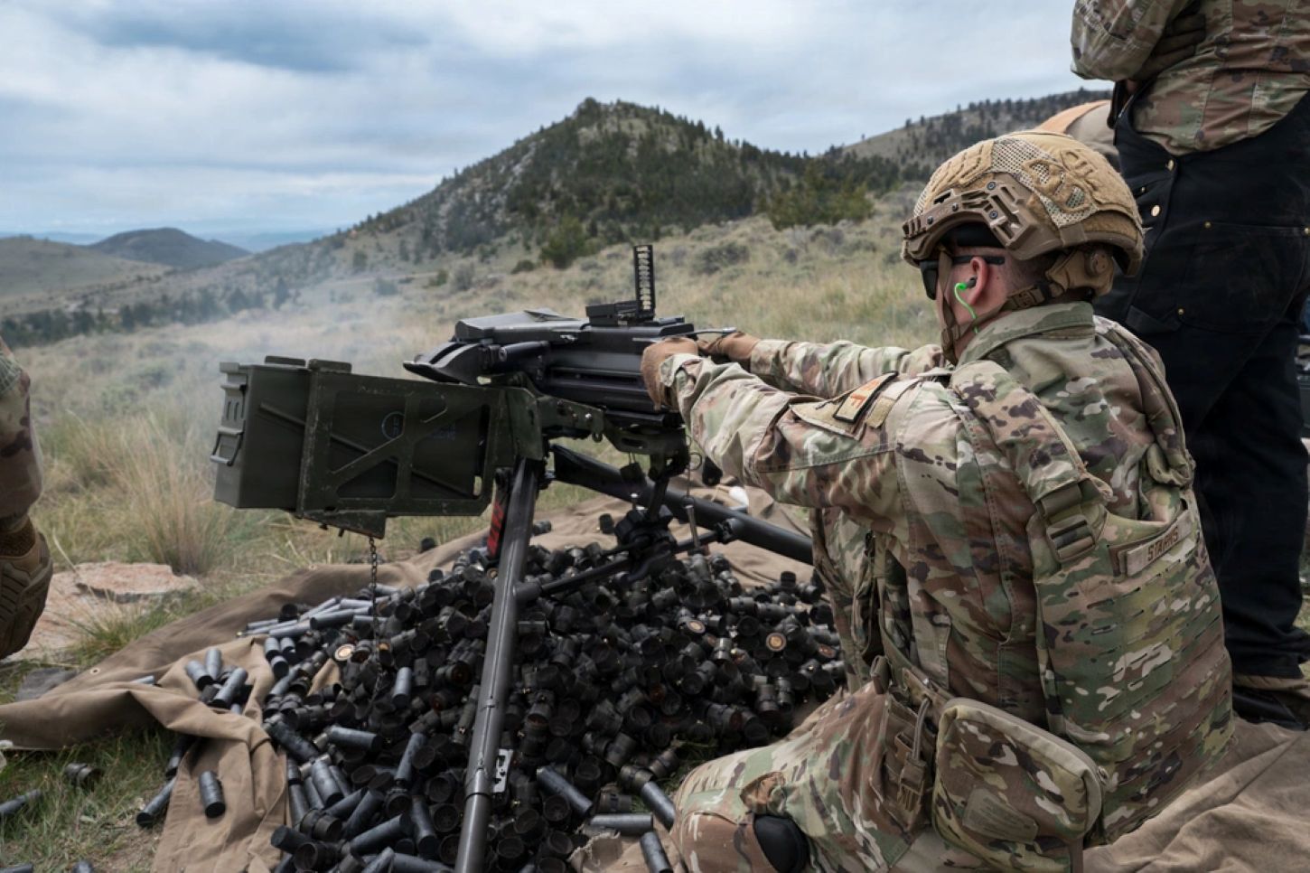 Military personnel shooting artillery 