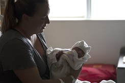 Photo by Senior Master Sgt. Beth Holliker, 180th Fighter Wing Ohio National Guard: A mother and her newborn daughter snuggle following an evaluation of the infant. 