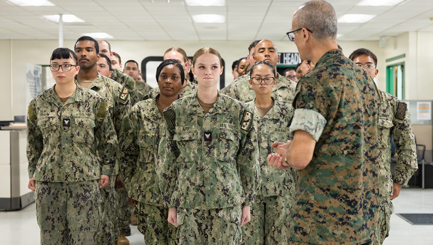 U.S. Navy Rear Adm. Guido Valdez, medical officer of the Marine Corps, addresses U.S. Navy Hospital Corpsman 3rd Class Hailey Arp during a visit to Naval Branch Health Clinic Marine Corps Recruit Depot