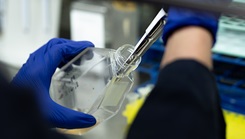 A researcher at the Uniformed Services University performs a precision liquid transfer
