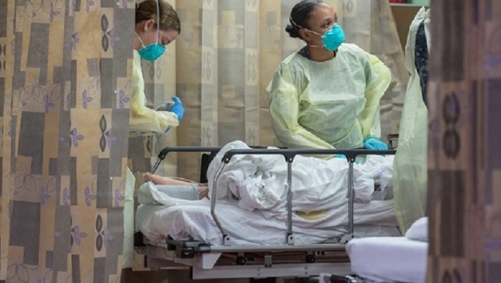 Image of Hospital personnel treating a patient on a stretcher. Click to open a larger version of the image.