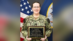 Lt. Cmdr. Devon Johnston, Military Program Director for NMCCL’s Combined Military-Civilian Psychiatry Residency Program poses with the Victor J. Teichnor plaque