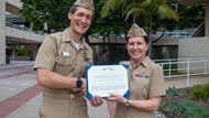 A NMCSD Pediatric PGY-3 resident receives an award from the the NMCSD Commanding Officer