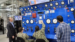 Dr. John Florian (left), head of Naval Submarine Medical Research Laboratory's (NSMRL) Warfighter Health and Protection department, supervises as ongoing research protocol in NSMRL's recently renovated Genesis hypo/hyperbaric chamber