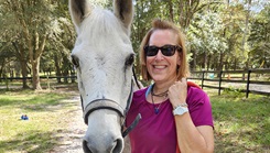Lt. Cmdr. Lynn Skinner, a nurse with Expeditionary Medical Facility 150 - Mike, poses with Rocky, an Arabian horse at Hope Therapy ranch in Middleburg, Fl.