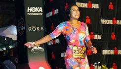 U.S. Navy Ens. Elisabeth Kaza crosses the finish line of an Ironman triathlon