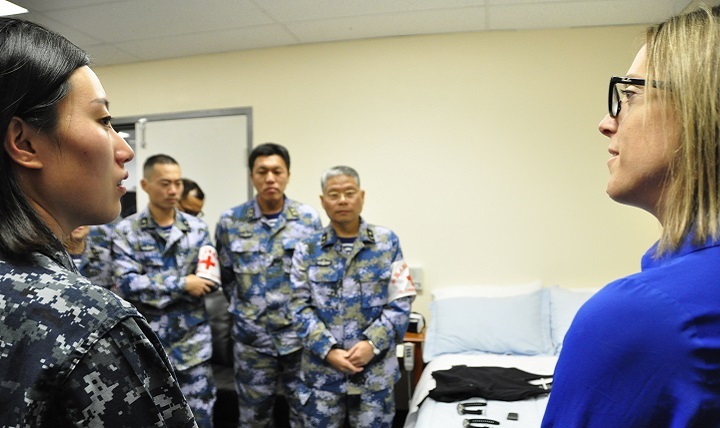 Dr. Rachel Markwald (right), a research scientist at NHRC, provides an overview of the research being conducting to detect the different stages of sleep and sleep disorders to visitors from the Chinese Navy. 