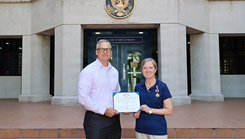 Lt. Cmdr. Dawn Weir, a microbiologist with Naval Medical Research Unit (NAMRU) INDO PACIFIC, receives the Meritorious Service Medal from Capt. Nicholas Martin, commanding officer of NAMRU INDO PACIFIC
