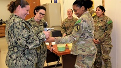 U.S. Navy Hospital Corpsman 1st Class Lindsey Pruett, on using a dynamometer to assess hand grip strength as U.S. Navy Lt. Cmdr. Cynthia DeArmon, course director, and fellow students observe