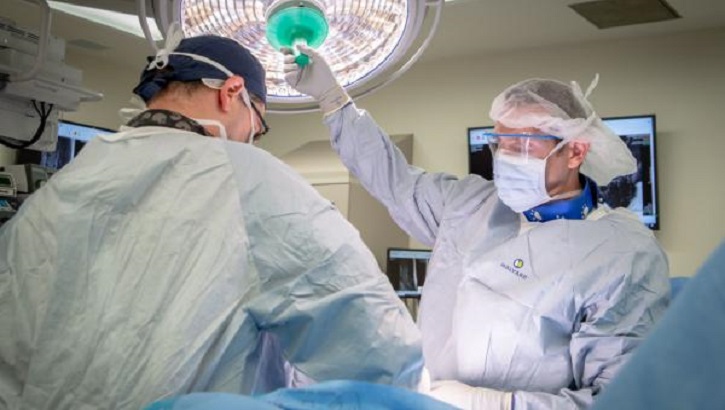 Two medical military personnel in an operating room