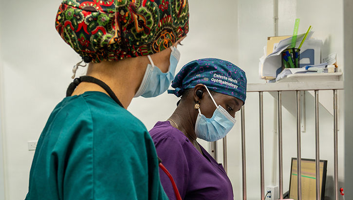 U.S. Air Force Lt. Col. Jessica Bolton, 96th Medical Group ophthalmologist, front, and Dr. Celeste Hines, Guyanese ophthalmologist, review patient records prior to beginning ophthalmological procedures