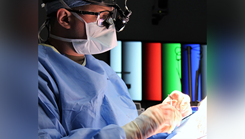 U.S. Army Maj. Andrew Jenzer, program director, oral and maxillofacial surgery residency, Womack Army Medical Center, performs a facial reconstruction.