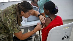 U.S. Army Spc. Rebecca Lageman, Army Forces Battalion medic, works with a member of Panama’s Ministerio de Salud to take the vitals of a young Panamanian boy during a Medical Readiness Training exercise